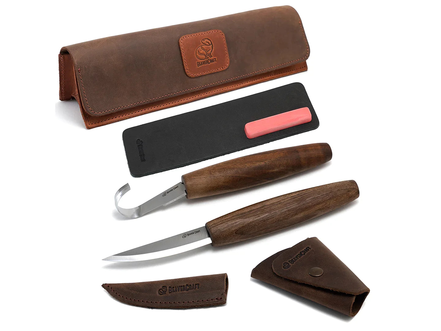 A set of spoon carving tools including a whittling knife, a wood carving spoon hook knife, and a leather strop, all with brown walnut handles and polished with linseed oil.
