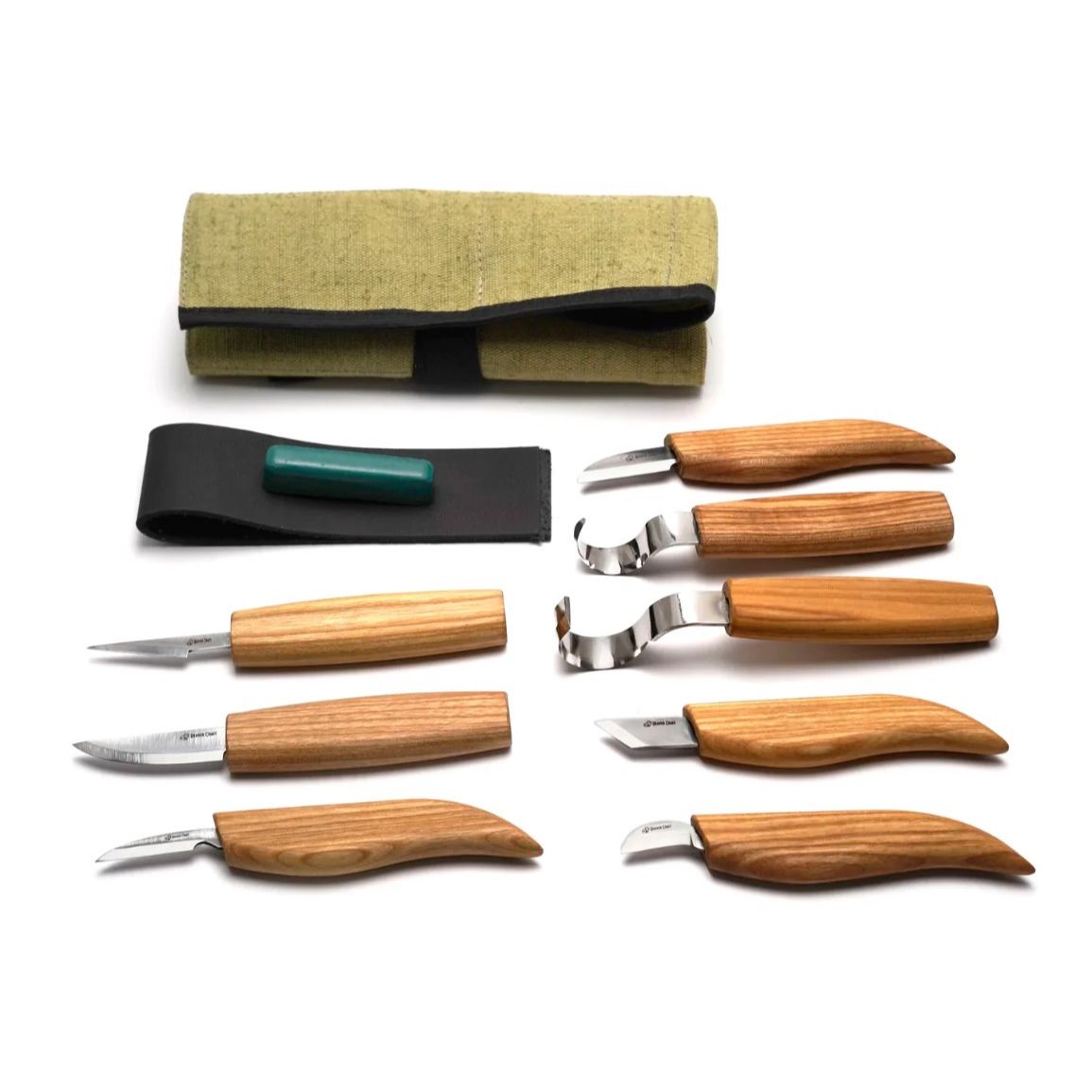 A set of 8 wood carving knives with beige handles and stainless steel blades, displayed alongside a green tool roll and a black leather strop with polishing compound.