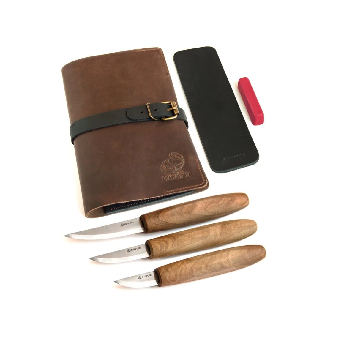 A set of three wood-handled knives with brown leather sheaths, along with a polishing compound and a leather strop.