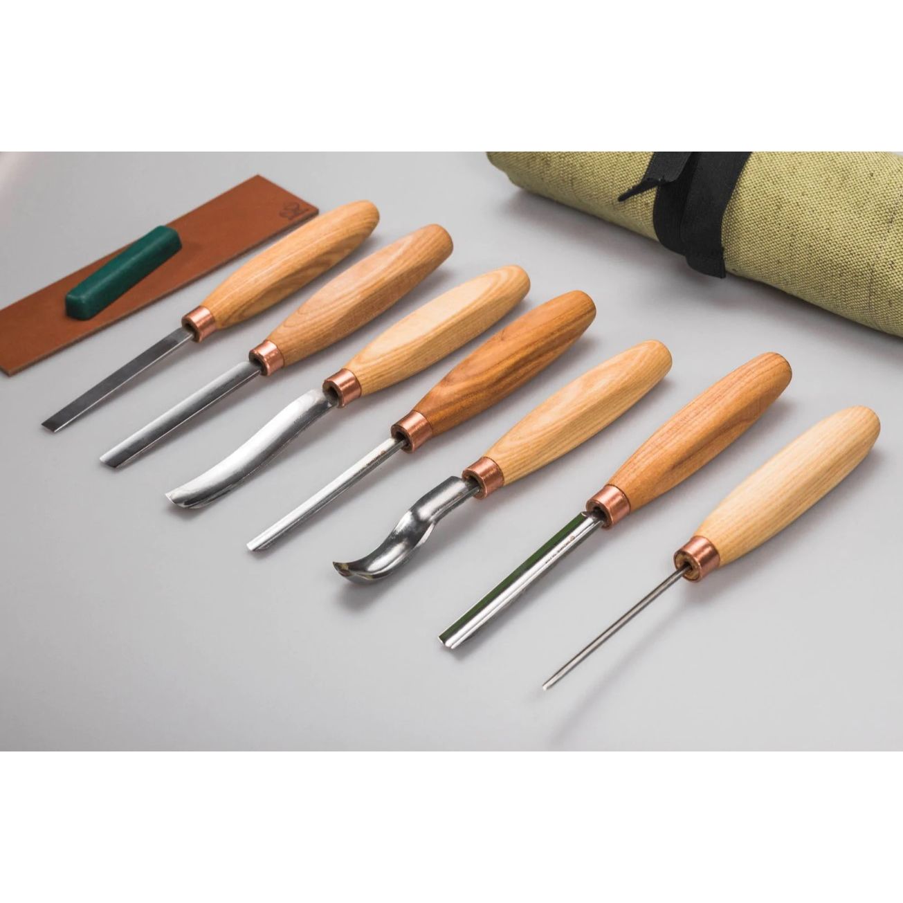 Complete set of woodcraft tools with sharpening kit and canvas organizer.